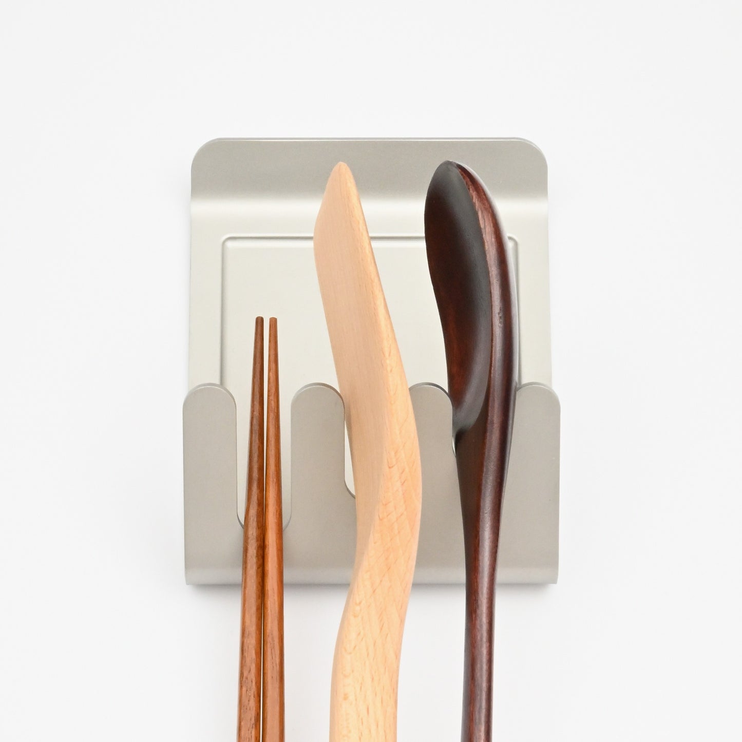 Alto holding chopsticks, a wooden spatula, and a spoon in its three slots